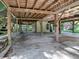 Open under-house area with concrete floor and wooden supports at 853 Cr 484, Lake Panasoffkee, FL 33538