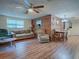 Living room with laminate floors, couches, and a wood accent wall at 853 Cr 484, Lake Panasoffkee, FL 33538