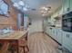 Kitchen with light green cabinets, wood floors and a dining area at 853 Cr 484, Lake Panasoffkee, FL 33538