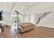 Living area with sectional sofa, hardwood floors, and access to balcony at 137 S Park Ave, Winter Garden, FL 34787