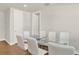 Dining room with glass table and six white chairs at 137 S Park Ave, Winter Garden, FL 34787