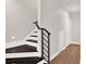 Modern staircase with dark wood treads and metal railing at 137 S Park Ave, Winter Garden, FL 34787