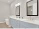 Bathroom with light blue double vanity and a bathtub at 137 S Park Ave, Winter Garden, FL 34787