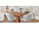 Kitchen features a dining area with modern wood table and white chairs at 137 S Park Ave, Winter Garden, FL 34787