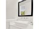Modern bathroom with a white sink and vanity, and a black framed mirror at 137 S Park Ave, Winter Garden, FL 34787
