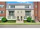 Two-story townhome with brick facade, metal roof, and landscaping at 137 S Park Ave, Winter Garden, FL 34787
