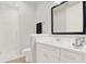 Bathroom with white vanity, walk-in shower, and mirror at 137 S Park Ave, Winter Garden, FL 34787