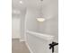 Upstairs hallway with a light fixture and railing at 137 S Park Ave, Winter Garden, FL 34787