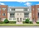 Two-story townhome with brick facade, metal roof, and landscaping at 137 S Park Ave, Winter Garden, FL 34787