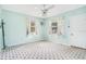 Light blue bedroom with floral curtains and patterned carpet at 1620 Morin St, Eustis, FL 32726