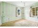 Bedroom with light green wood paneling and patterned carpet at 1620 Morin St, Eustis, FL 32726