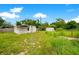 Overgrown backyard with sheds and tall grass at 1620 Morin St, Eustis, FL 32726