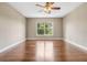 Spacious bedroom with wood floors and a ceiling fan at 15847 Wilkinson Dr, Clermont, FL 34714