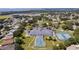 Community clubhouse with pool, tennis courts, and surrounding homes at 6002 Sailboat Ave, Tavares, FL 32778