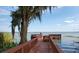 Wooden dock extending over calm lake water, offering peaceful views at 6002 Sailboat Ave, Tavares, FL 32778