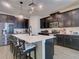 Modern kitchen with dark cabinetry, island, and stainless steel appliances at 15162 Book Club Rd, Winter Garden, FL 34787