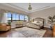 Luxurious main bedroom with a large window offering scenic views and an ensuite bath at 7616 Lily Ct, Groveland, FL 34736