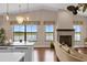 Spacious living area with a fireplace and breathtaking lake views at 7616 Lily Ct, Groveland, FL 34736