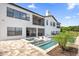 Two-story house with a tan exterior, white garage door, and palm trees in the front yard at 7616 Lily Ct, Groveland, FL 34736