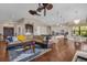 Open concept living space showcasing a comfortable sectional sofa and hardwood floors at 7616 Lily Ct, Groveland, FL 34736