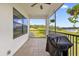 Relaxing screened porch overlooking lake with built-in grill at 7616 Lily Ct, Groveland, FL 34736