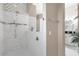 Elegant bathroom with a large walk-in shower and marble tile at 7616 Lily Ct, Groveland, FL 34736