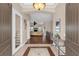 Elegant entryway with hardwood floors and view to living room at 7616 Lily Ct, Groveland, FL 34736