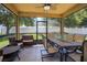 Relaxing screened porch with seating and a dining table at 170 Prairie Falcon Dr, Groveland, FL 34736