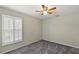 Spacious bedroom featuring a ceiling fan and window shutters at 114 Compass Rose Dr, Groveland, FL 34736