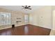 Living room with a stone-textured accent wall and dark wood-look tile floors at 114 Compass Rose Dr, Groveland, FL 34736