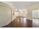 Open living space with dark brown tile floors and multiple entrances at 114 Compass Rose Dr, Groveland, FL 34736
