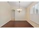 Formal dining room with a chandelier and dark wood-look tile floors at 114 Compass Rose Dr, Groveland, FL 34736