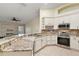 Modern kitchen with granite countertops and stainless steel appliances at 114 Compass Rose Dr, Groveland, FL 34736