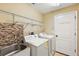 Laundry room with washer, dryer, utility sink, and shelving at 114 Compass Rose Dr, Groveland, FL 34736