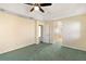 Bright bedroom with carpet, ceiling fan and access to bathroom at 114 Compass Rose Dr, Groveland, FL 34736