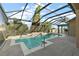 Inviting screened pool and spa with covered patio at 114 Compass Rose Dr, Groveland, FL 34736