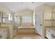 Bathroom with a soaking tub, shower, and double vanity at 114 Compass Rose Dr, Groveland, FL 34736