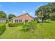 Home's backyard features a screened patio and green lawn at 3921 Doune Way, Clermont, FL 34711