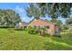 Landscaped backyard with lush lawn and mature trees at 3921 Doune Way, Clermont, FL 34711