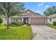 One-story house with landscaped yard and driveway at 3921 Doune Way, Clermont, FL 34711