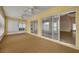 Sunroom with sliding glass doors, carpet, and two ceiling fans at 3921 Doune Way, Clermont, FL 34711
