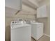 Laundry room with washer, dryer and cabinets at 3921 Doune Way, Clermont, FL 34711