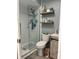 Updated bathroom with a walk-in shower, floating shelves and gray walls at 2021 Donnelly Pl, Mount Dora, FL 32757