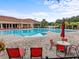 Relaxing pool area with red lounge chairs at 3656 Solana Cir # F, Clermont, FL 34711