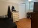 Well-lit bedroom with hardwood floors and a large closet at 2524 Good Homes Rd, Orlando, FL 32818