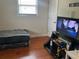 Small bedroom with a bed and TV stand at 2524 Good Homes Rd, Orlando, FL 32818