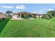 House exterior and expansive grassy backyard at 533 Grand Vista Trl, Leesburg, FL 34748