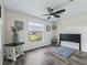 Spacious bedroom with ceiling fan, hardwood floors, and large window at 533 Grand Vista Trl, Leesburg, FL 34748