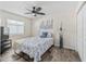 Cozy bedroom with ceiling fan, hardwood floors and a comfortable bed at 533 Grand Vista Trl, Leesburg, FL 34748