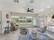 Bright sunroom with comfy seating and view of backyard at 533 Grand Vista Trl, Leesburg, FL 34748